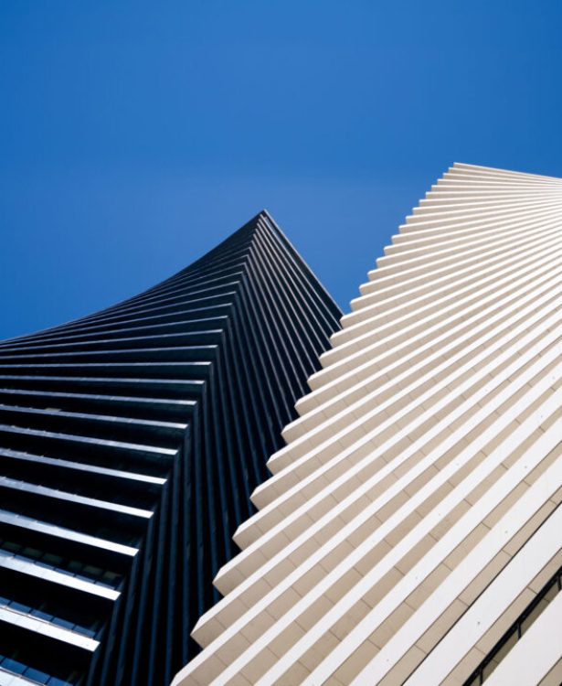 A low angle shot of Axis Towers in Tbilisi, Georgia under a blue sky