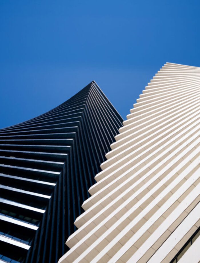 A low angle shot of Axis Towers in Tbilisi, Georgia under a blue sky